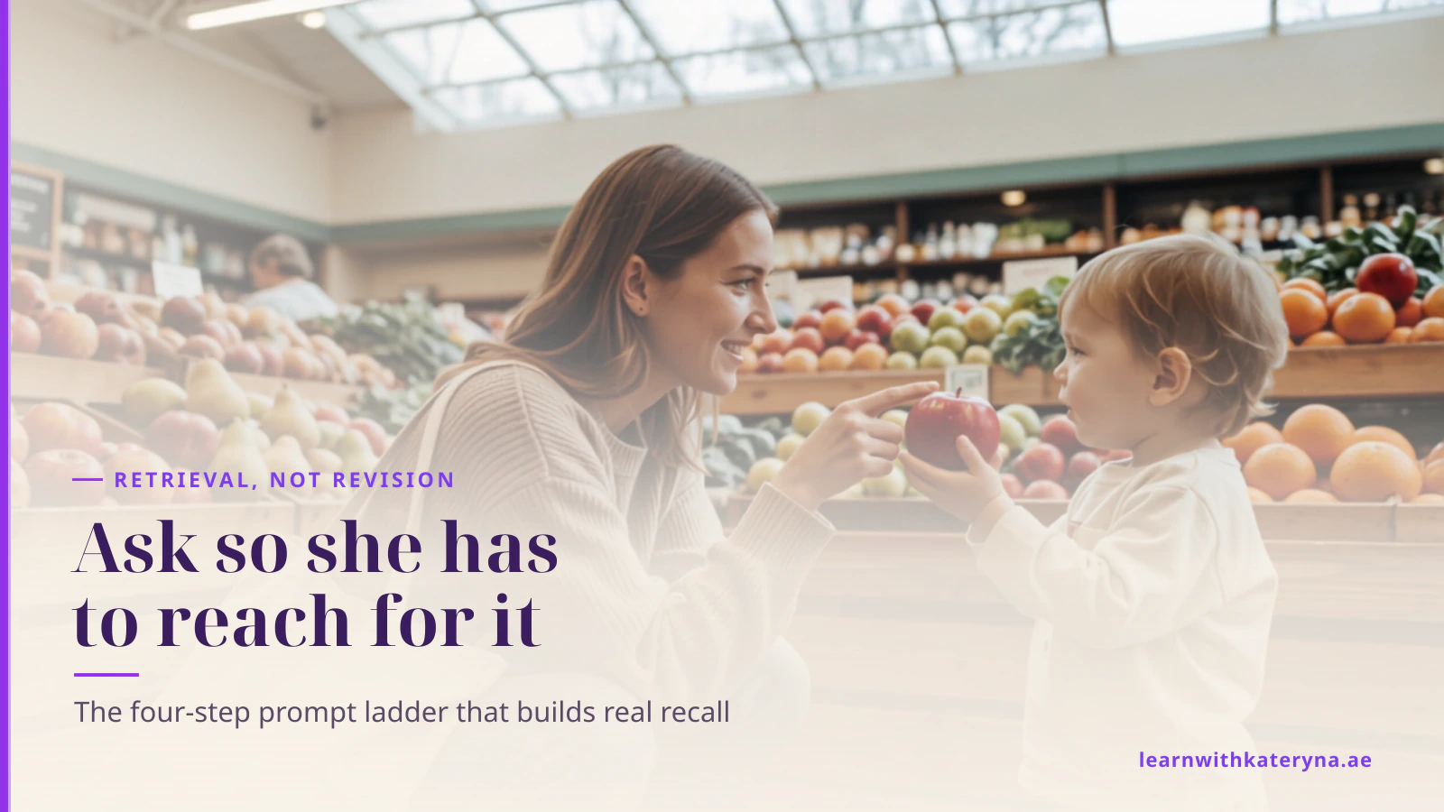 Mother crouching to her toddler's eye level at a market fruit display while the child holds up a red apple