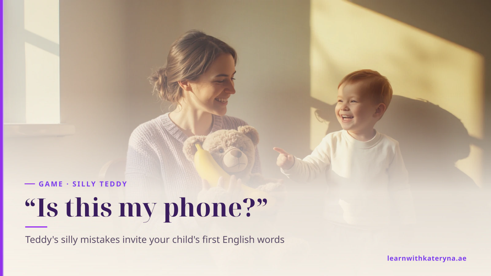 A mother in a sunny kitchen holds a teddy bear clutching a banana while her toddler laughs and points at it